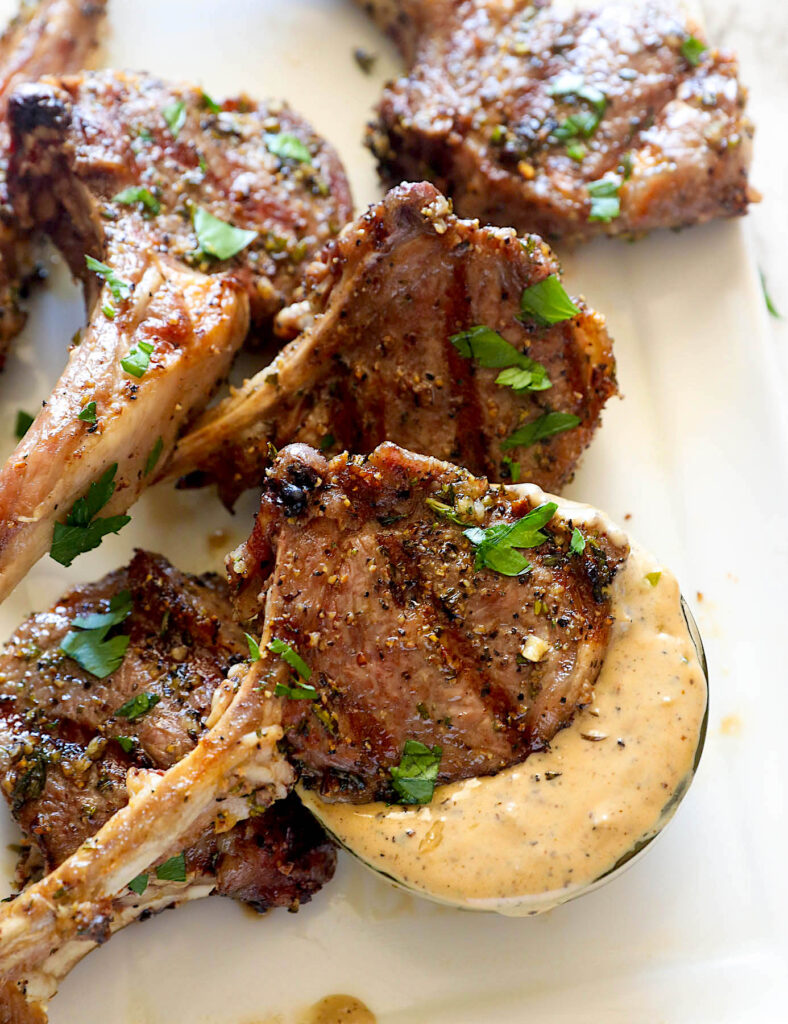 Dipping a delicious grilled lamb lollipop into a decadant remoulade
