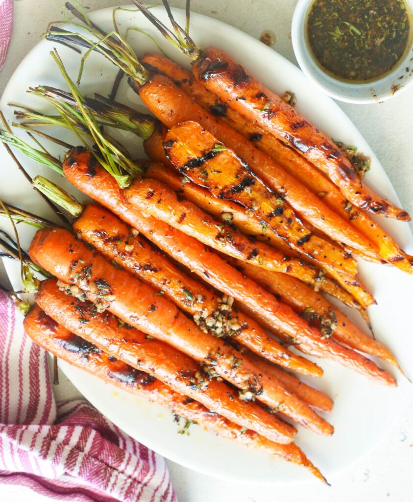 Grilled Carrots served in a plate topped with spices